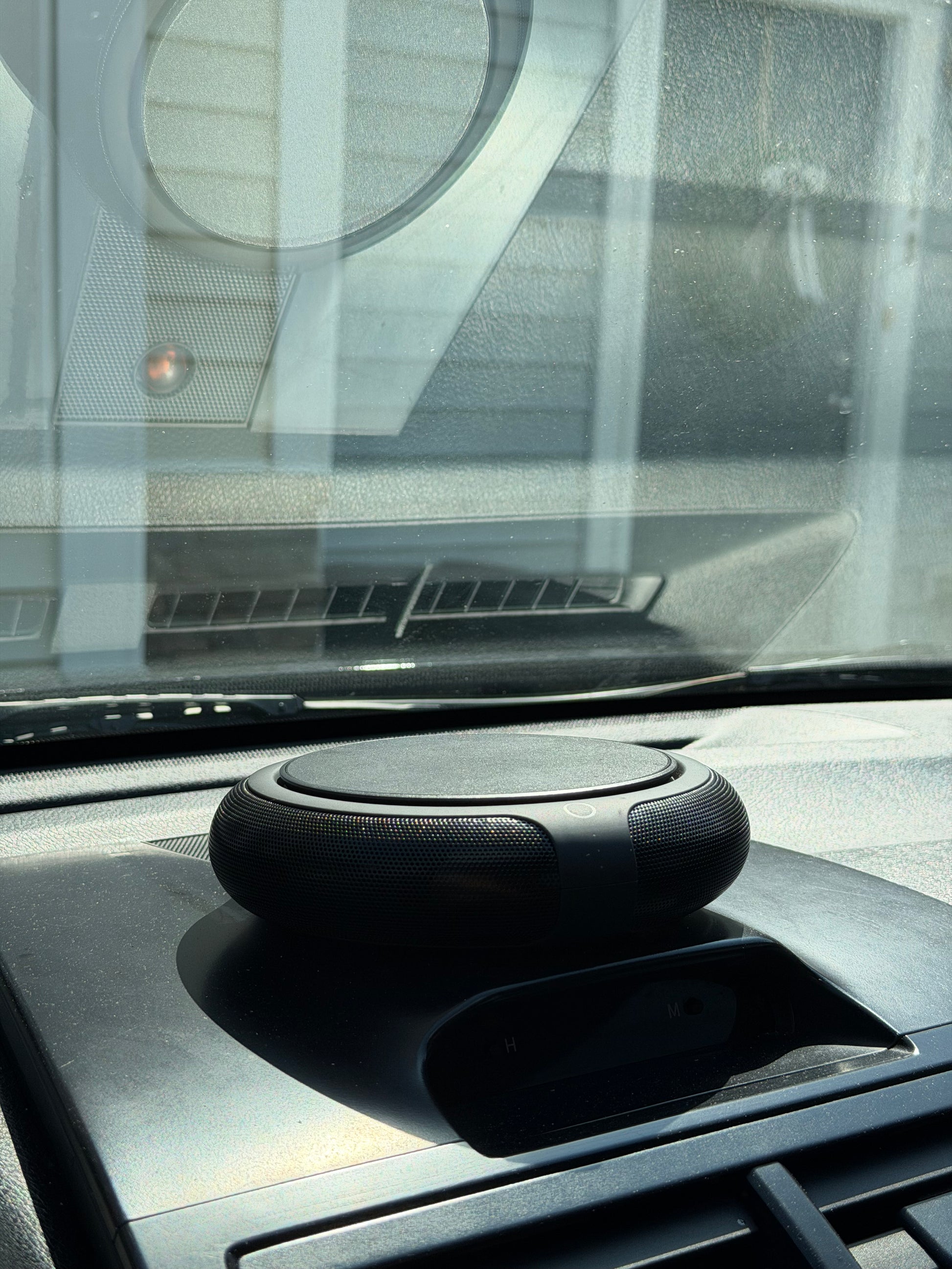 Carisma™ Solar Air Car Solar Purifier mounted inside a vehicle, showing sleek design and solar panel for air purification.