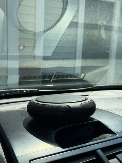 Carisma™ Solar Air Car Solar Purifier mounted inside a vehicle, showing sleek design and solar panel for air purification.